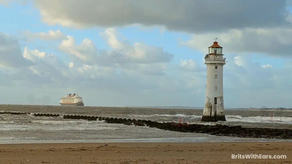 Disney Dream sails out in to the Irish sea with New Brighton lighthouse in the foreground