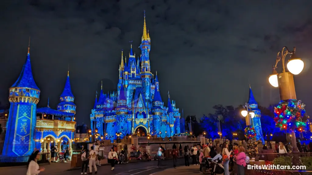 The castle at Magic Kingdom with a wintery scene projected on to it